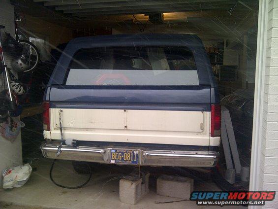 Two-tone white and blue SUV rear view, parked in garage