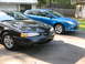 2012 Ford Focus - Two cars parked in a driveway, one is a blue Ford Focus.