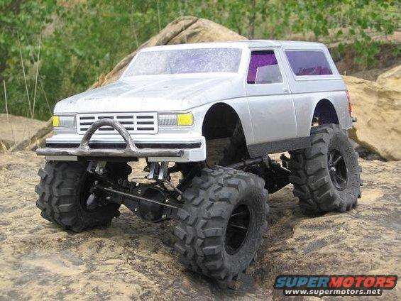 RC rock crawler truck with oversized tires on rocky terrain