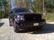2007 Dodge Durango - A black Dodge Durango is parked on a gravel road with trees in the background.