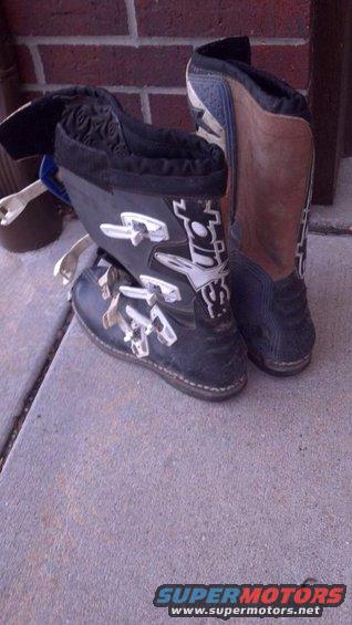 Pair of black and brown motorcycle boots with white buckles