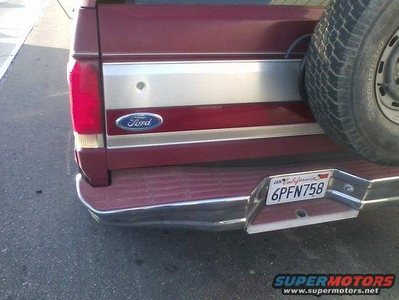 Maroon Ford Bronco rear with spare tire, chrome bumper, and California license plate 6PFN758