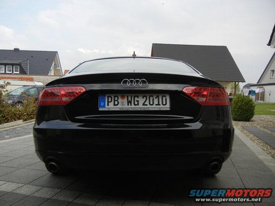 Black Audi A5 rear view, license plate PB WG 2010, with visible exhaust pipes and taillights