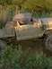 1990 Ford Bronco - This heavily damaged pickup truck appears to be stuck in a muddy, overgrown area.