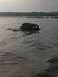 1990 Ford Bronco - A vehicle is submerged in water, with only its upper portion visible above the waves.