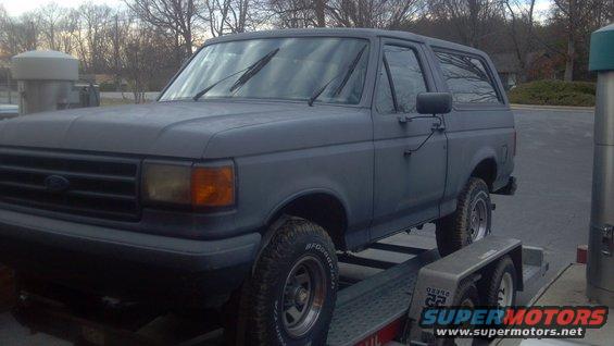 Gray 1987 Ford Bronco on a trailer, front 3/4 view