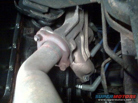 Close-up of exhaust manifold and pipe on a vehicle engine