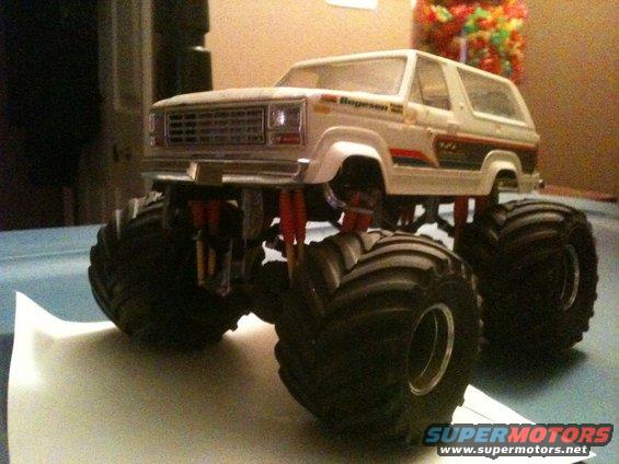 Model monster truck with large tires and lifted suspension