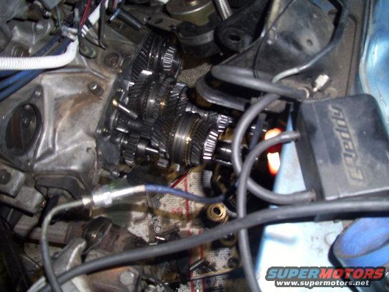 close-up of car transmission gears and wiring, with an E-manage box visible