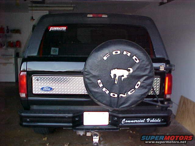 Rear of a black 1995 Ford Bronco with a spare tire cover and diamond plate panel