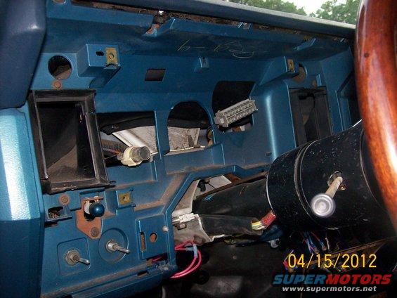 Blue dashboard with exposed wiring and steering column. Date stamp reads 04/15/2012