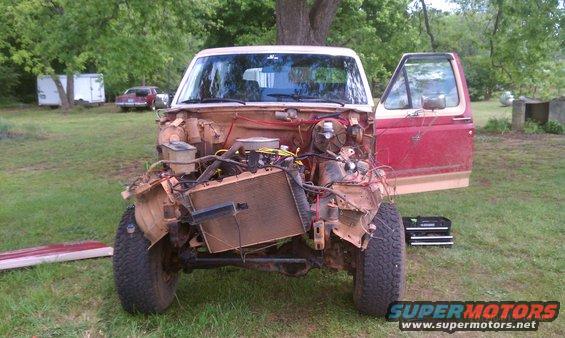 1987 Ford Bronco front end disassembled, engine bay exposed, driver's door open
