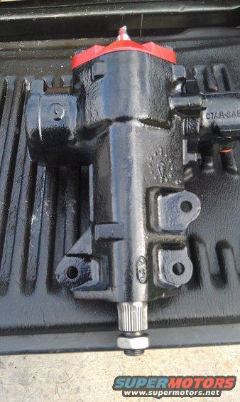 Black steering gear box with red top cap and splined shaft