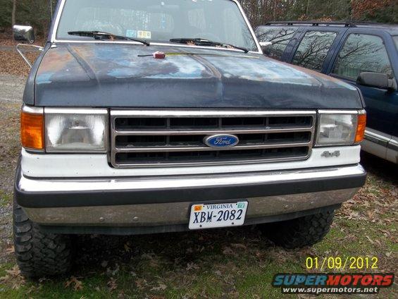 Front view of a dark blue 1989 Ford Bronco with a chrome grille and a Virginia license plate