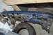 1986 Ford Bronco - The underside of a vehicle's fender shows significant rust and damage, with a spare tire visible below.