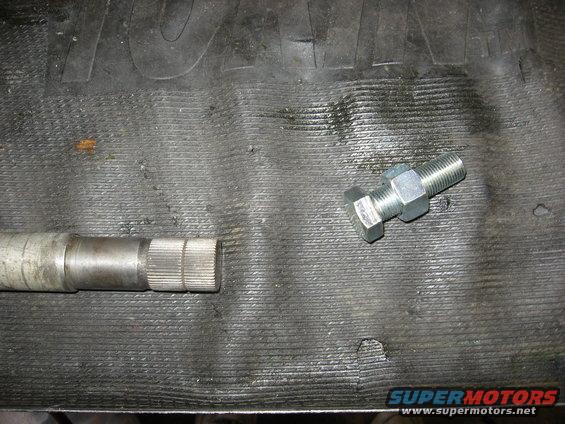 Close-up of a splined shaft next to a bolt with a nut