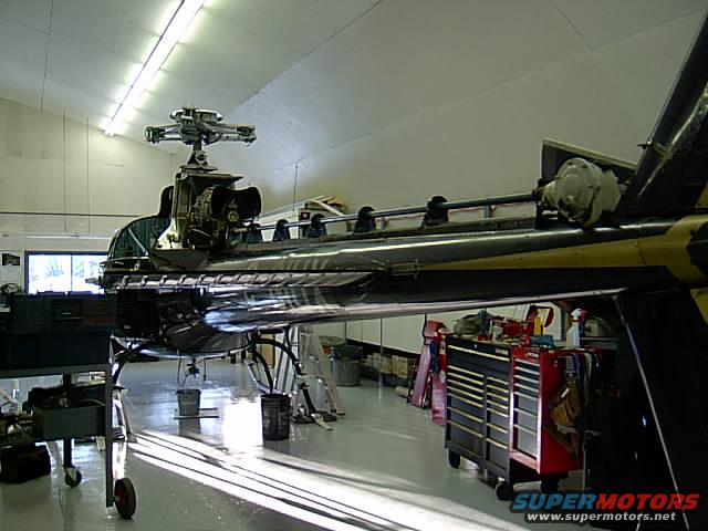 Helicopter in a hangar, side view, with yellow and black stripes