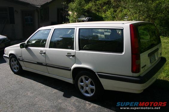 White 1997 Volvo 850 wagon, rear 3/4 view, parked on asphalt driveway