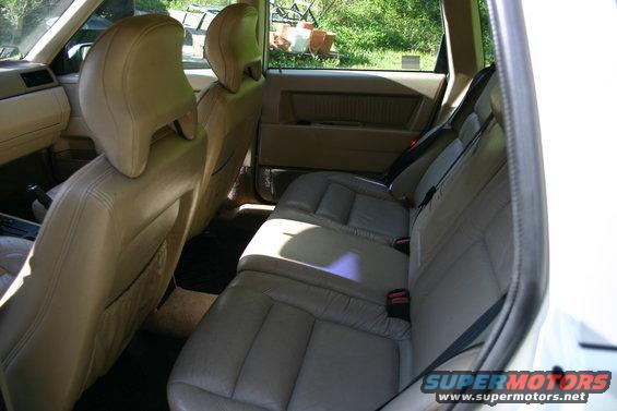 Interior view of a 1997 Volvo 850 station wagon, showing tan leather seats and door panels