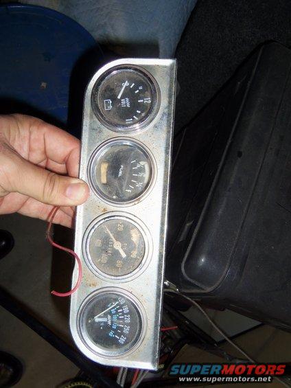 Gauge cluster with voltmeter, fuel, oil pressure, and temperature gauges. Voltmeter reads around 11-12V