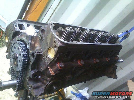 Engine block with timing chain and valve springs visible