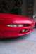 1996 Ford Probe - Front view of a red 1996 Ford Probe, showing the bumper, headlights, and fog lights.