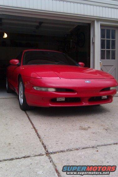 Red 1996 Ford Probe parked in front of garage