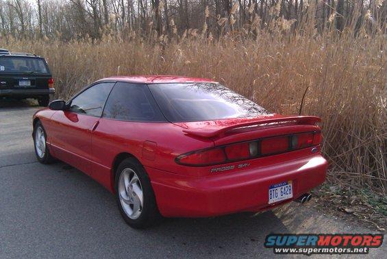 Red 1996 Ford Probe with a rear spoiler and a license plate reading BTG 6428