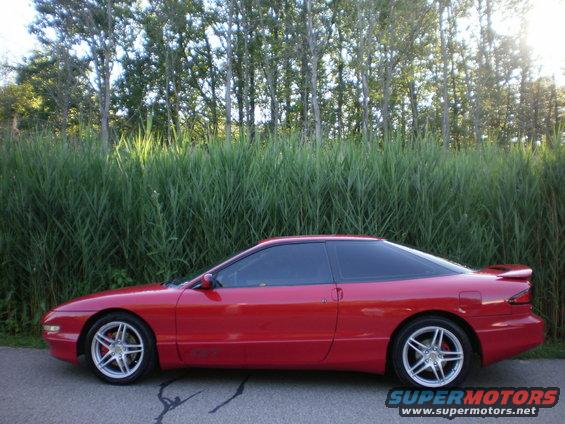 Red 1996 Ford Probe coupe, side view