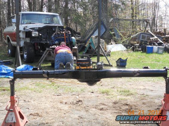1978 Ford Bronco with engine removed, being worked on outdoors