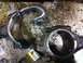 1990 Ford Bronco - Damaged engine connecting rods lie on a stained surface, indicating a severe mechanical failure.