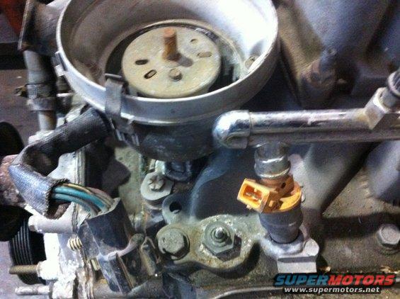 Close-up of engine with fuel injector and distributor cap