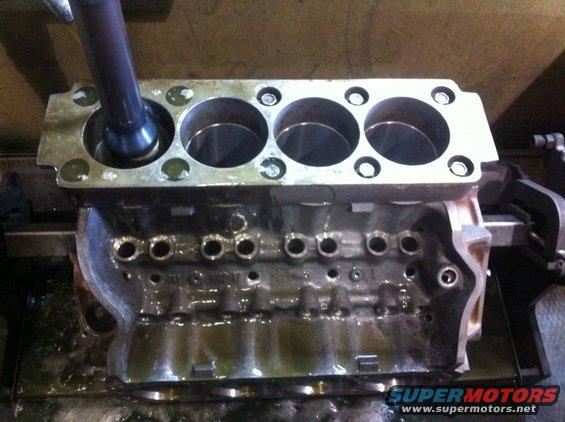 Engine block being honed with a tool in the cylinders
