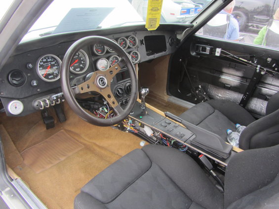 Car interior with aftermarket gauges and racing steering wheel