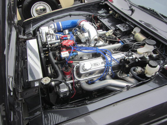 Chrome Ford Motorsport engine with blue intake and red spark plug wires