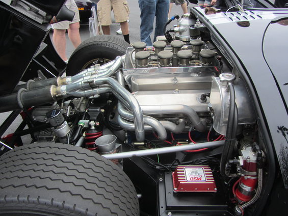 Engine bay showing V8 engine with chrome headers, dual exhaust, and an MSD ignition box