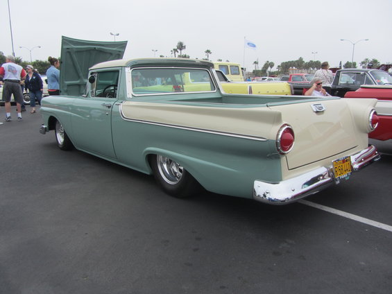 Two-tone 1957 Ford Ranchero with cream and teal paint, lowered suspension, and chrome bumpers