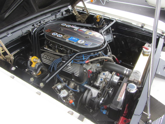 Engine bay with a V8 engine, chrome air cleaner, and blue spark plug wires