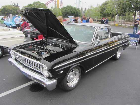 Black pickup truck with hood open, showing engine. Chrome trim and wheels