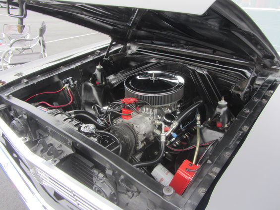 1964 Ford Ranchero engine bay with chrome air cleaner, V8 engine, and red distributor cap