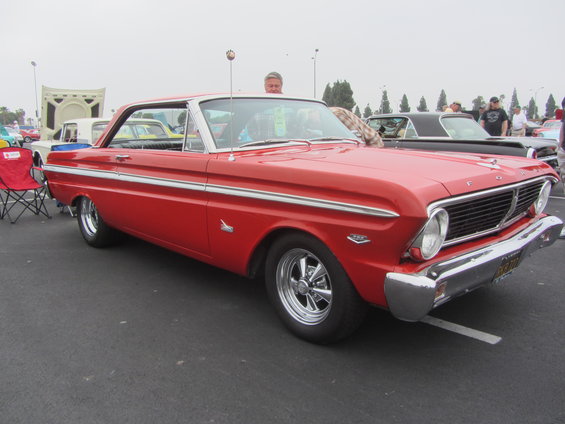 Red 1963 Ford Falcon Futura with chrome trim and aftermarket wheels