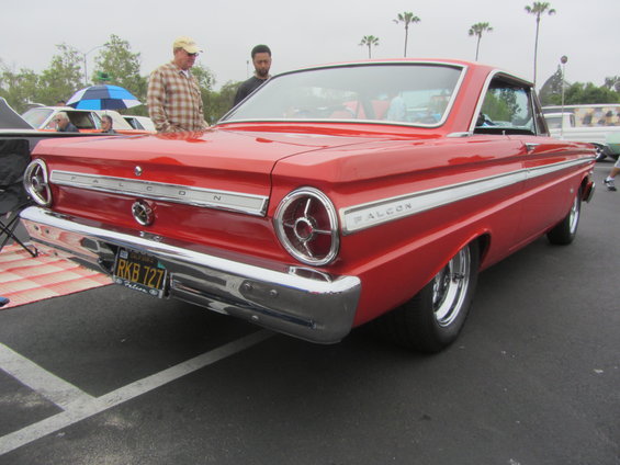Red classic car with 'FALCON' badging on the rear quarter panel. License plate reads RKB 727