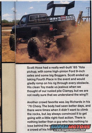 Black 1985 Toyota pickup truck with oversized tires and a large rear spoiler, kicking up dust on a dirt track