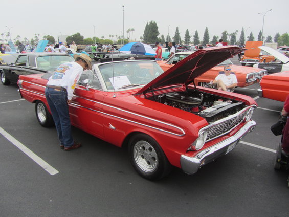 Red 1964 Ford Ranchero convertible with hood open, viewed from the front 3/4 angle
