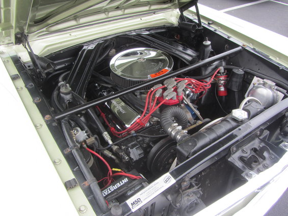1964 Ford Ranchero engine bay with V8 engine, chrome air cleaner, and red spark plug wires