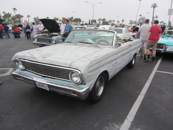 1964 Ford Falcon convertible with primer finish, parked at an outdoor car show