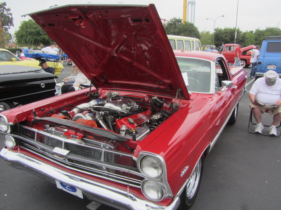 Red 1965 pickup truck with hood open, twin turbos visible