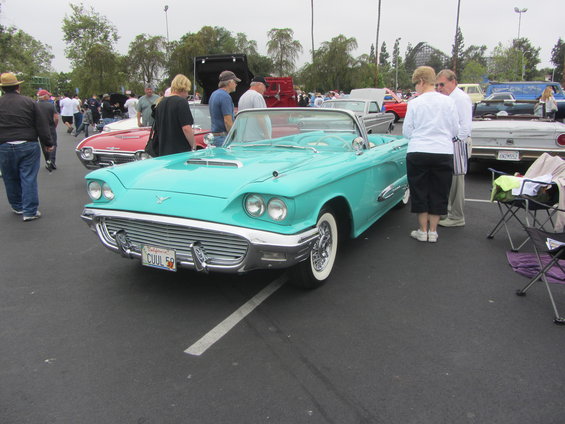 1958 Ford Thunderbird convertible with a turquoise paint job and whitewall tires. License plate reads CUUL 58