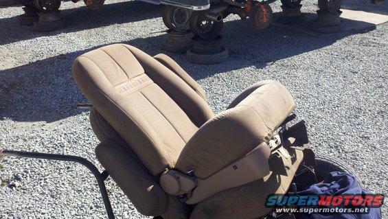Tan car seat with "BRONCO" embossed on headrest, angled view