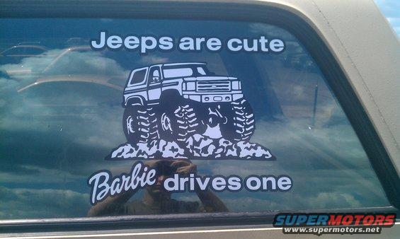 Window sticker of a monster truck with text "Jeeps are cute" and "Barbie drives one"
